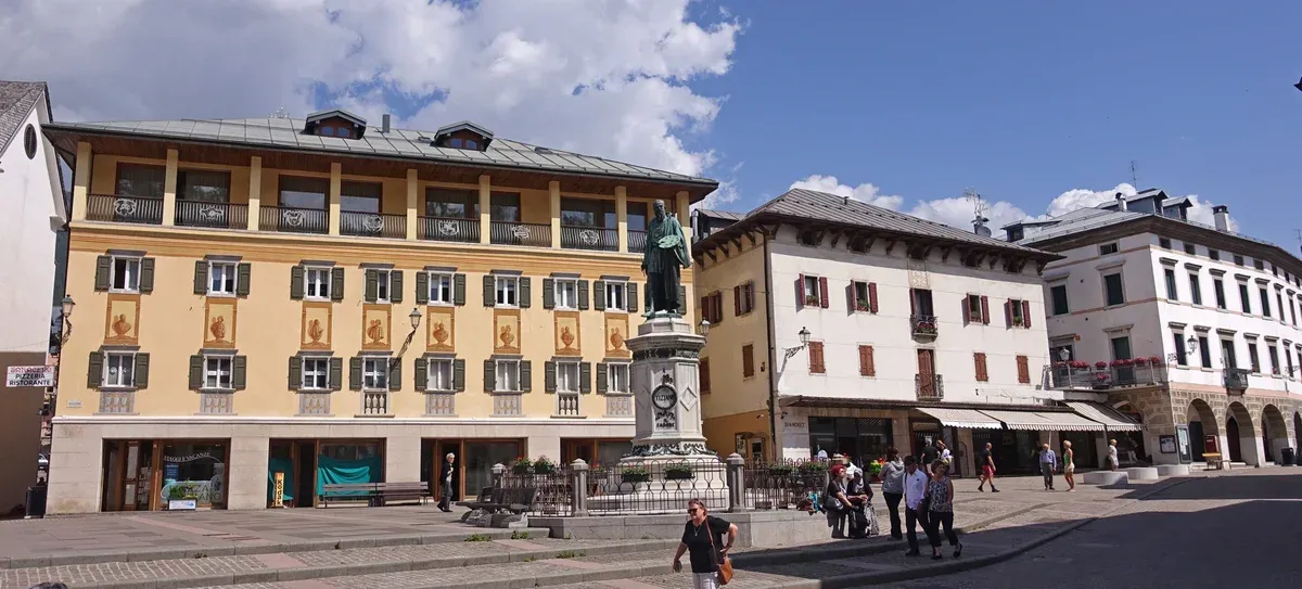 The main square of Pieve di Cadore with colourful facades and the Titian monument